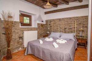 a bedroom with a bed with towels on it at Molino de Santa Águeda in Jerez del Marquesado