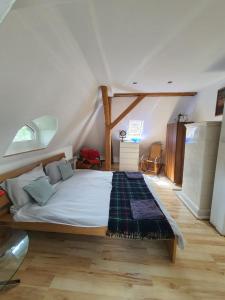a bedroom with a large bed in a attic at SkyView Apartment in Jelenia Góra