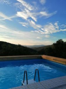 a swimming pool with a view of the mountains at Retiro da Cava, piscina privada in Oleiros