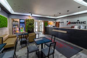 a restaurant with tables and chairs and a bar at Atlantic Aparthotel in Krakow
