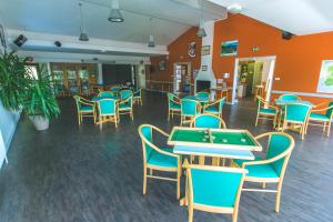 a room with a pool table and chairs at VVF Les Fontaines des Vosges in Saales