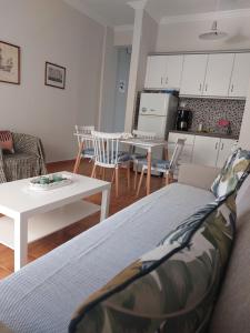 a living room with a couch and a table at Waterfront Spitaki Nea Iraklitsa in Iraklitsa