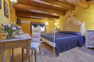 a bedroom with a bed and a table and a desk at Locanda del Gagini in Palermo