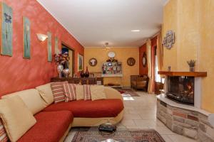 a living room with a couch and a fireplace at Villa Lolù in Terranuova Bracciolini