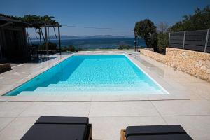 a swimming pool with blue water in a house at Pine House in Áyioi