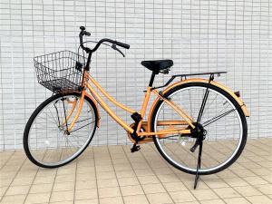 an orange bike with a basket parked in a room at J Hotel Rinku in Tokoname
