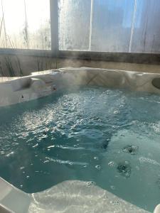 a bath tub filled with lots of blue water at Love Space Sensory Spa & relax suite in Santa Maria delle Mole