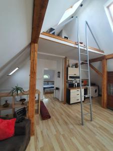 a room with a loft bed and a living room at SkyView Apartment in Jelenia Góra