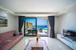a living room with a couch and a table at KaşKalkan Honeymoon Villa with Seaview in Kalkan