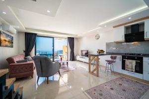 a large living room with a kitchen and a living room at KaşKalkan Honeymoon Villa with Seaview in Kalkan