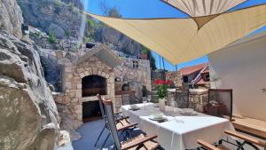 a patio with a table and a stone oven at Apartment Vise - Old Town Center, Stone Terrace in Omiš
