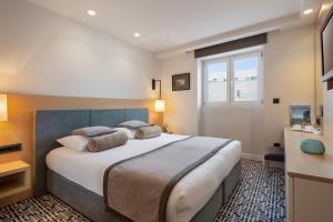 a bedroom with a large bed and a window at Royal Neptun Hotel in Dubrovnik