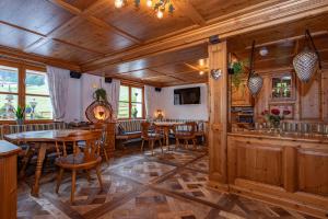 ein Esszimmer mit Holzwänden, Tischen und Stühlen in der Unterkunft Hotel Alpenrose in Gargellen