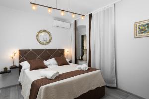 a bedroom with a large bed and a mirror at Palace Penthouse with Terrace in Split Centre Old Town in Split +15 photos