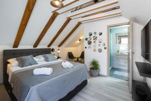 a bedroom with a large bed with towels on it at Palace Penthouse with Terrace in Split Centre Old Town in Split