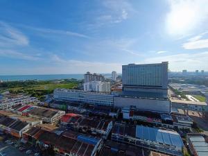 an aerial view of a city with buildings and the ocean at Straits Residence Melaka Private Suites in Melaka