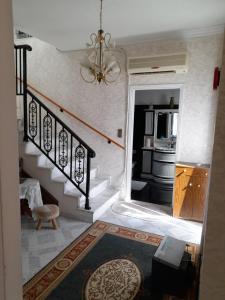 a room with a staircase and a kitchen with a microwave at Art House Syros in Ermoupoli