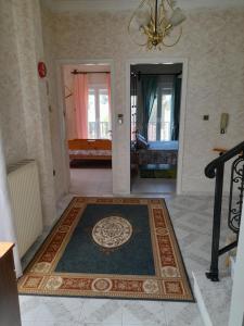 a living room with a rug on the floor at Art House Syros in Ermoupoli