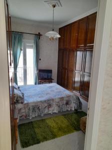 a bedroom with a bed and a large window at Art House Syros in Ermoupoli