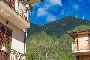 uma vista para uma montanha entre dois edifícios em Verde Coccola - Casa Vacanze em Ospedaletto dʼAlpinolo