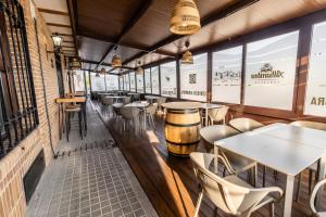 a row of tables and chairs in a restaurant at Hostal El Bomba in Las Pedroñeras