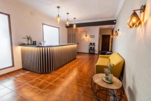 a living room with a couch and a table at Hostal El Bomba 