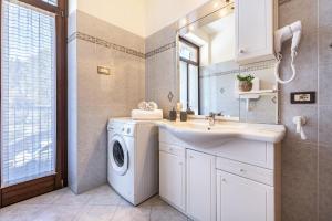 a bathroom with a washing machine and a sink at Appartamenti Villa Belvedere in Arco +126 photos