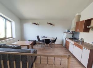 a living room with a couch and a table in a kitchen at K-Town - Cozy Apartment Near the City Center in Kaunas