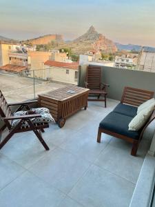 a balcony with chairs and a view of a mountain at Eleusis luxury flat in Elefsina