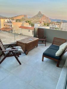 a balcony with chairs and a view of a mountain at Eleusis modern flat,carpark in in Elefsina