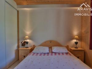 a bedroom with a bed with two night stands and two lamps at Appartement Le Grand-Bornand, 2 pièces, 4 personnes - FR-1-391-107 in Le Grand-Bornand