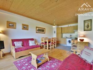 a living room with a red couch and a table at Appartement Le Grand-Bornand, 2 pièces, 4 personnes - FR-1-391-107 in Le Grand-Bornand