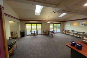 a large room with tables and chairs and windows at Days Inn by Wyndham Harrisburg North in Harrisburg