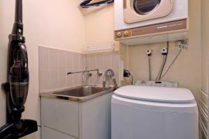 a small bathroom with a sink and a microwave at Lantern 1 Bedroom Balcony with amazing view in Thredbo