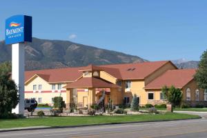 a hotel with a sign in front of a building at Baymont by Wyndham Salida in Salida
