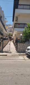 a car parked in front of a building with a fence at ANASTASIA studio in Kavala