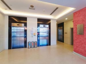 a lobby with multiple elevators in a building at Straits Residence Melaka Private Suites in Melaka