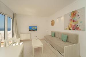 a living room with a couch and a table at Apartaments Andreas in Colònia de Sant Jordi