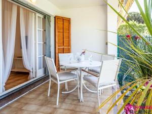 a white table and chairs on the balcony of a house at Voramar III baixos 3ero in S'agaro