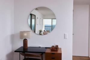 a room with a desk and a mirror at Porto Sunset suite in Vila Nova de Gaia