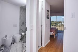 a bathroom with a sink and a toilet in a room at Porto Sunset suite in Vila Nova de Gaia