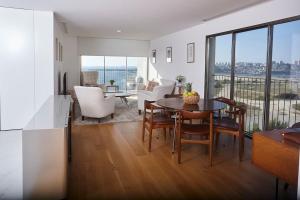 a kitchen and living room with a table and chairs at Porto sunset suite in Vila Nova de Gaia