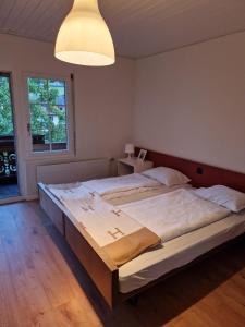 a bedroom with a large bed in a room at Hotel Chalet Bellerive in Spiez