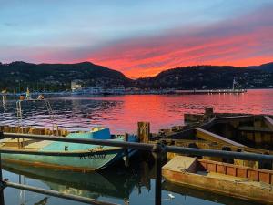 a couple of boats docked at a dock with a sunset at Indomabile Home Como in Cantù