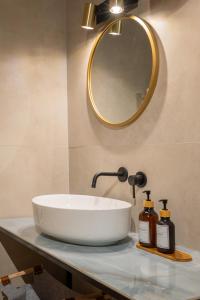 a bathroom with a white sink and a mirror at Osvaldo - parcheggio e giardino privato in San Giovanni in Persiceto