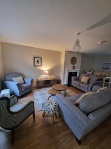 a living room with two couches and a table at 4 Castle Court in Killyhevlin