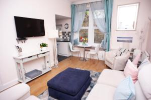 a living room with a couch and a table at Bees Townhouse- Cupar in Cupar