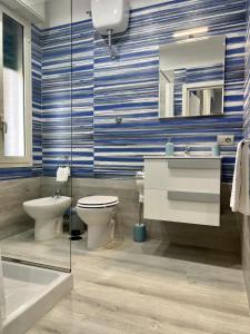 a bathroom with a toilet and a sink and a mirror at punto house in Naples +13 photos