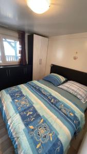 a bedroom with a bed with a blue comforter at Villa Renata in Pirovac