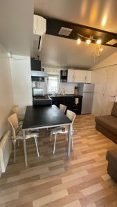 a kitchen and a dining room with a table and chairs at Villa Renata in Pirovac